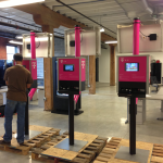NV3 workers put the finishing touches on a batch of custom branded NSK-10 Solar Kiosks.